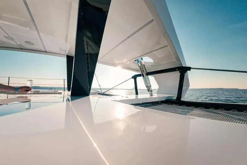  Yacht Photos Pics 2024 Wave Wave60 yacht deck with ocean view and person holding a drink.