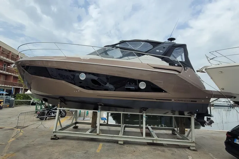  Yacht Photos Pics 2025 Cranchi Z35 yacht displayed on a stand at a marina.