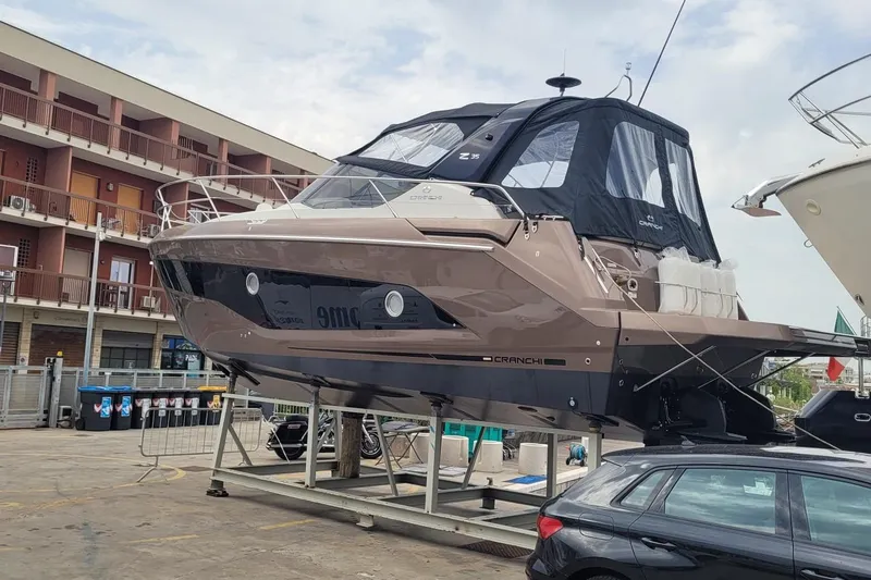  Yacht Photos Pics 2025 Cranchi Z35 yacht on display, elevated on a platform in a marina setting.