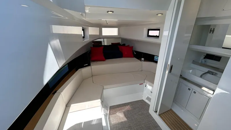  Yacht Photos Pics Interior of 2025 De Antonio Yachts D36, featuring modern seating and compact kitchenette.