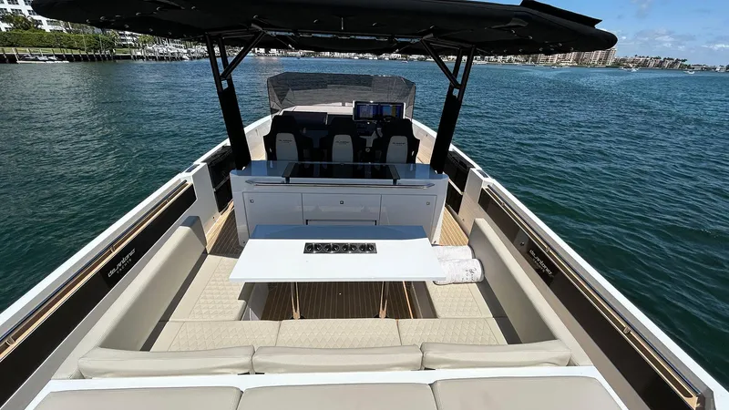  Yacht Photos Pics 2025 De Antonio Yachts D36 luxury boat interior with seating and table on open water.