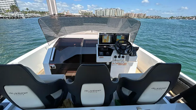  Yacht Photos Pics 2025 De Antonio Yachts D36 helm with three seats, modern controls, and ocean view.