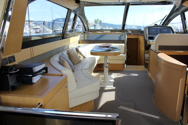 Happy Go Lucky Yacht Photos Pics Luxurious interior of a 2009 Riva SportRiva 56 yacht with elegant seating and panoramic windows.