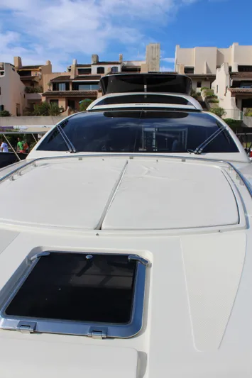 Happy Go Lucky Yacht Photos Pics 2009 Riva SportRiva 56 yacht docked with modern architecture in the background.