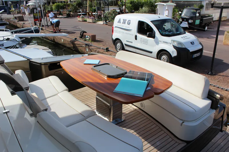 Happy Go Lucky Yacht Photos Pics 2009 Riva SportRiva 56 yacht deck with elegant seating and wooden table.