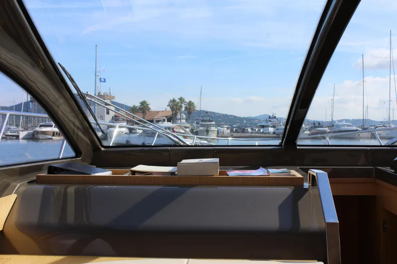 Happy Go Lucky Yacht Photos Pics Interior view of a 2009 Riva SportRiva 56 yacht with marina in the background.