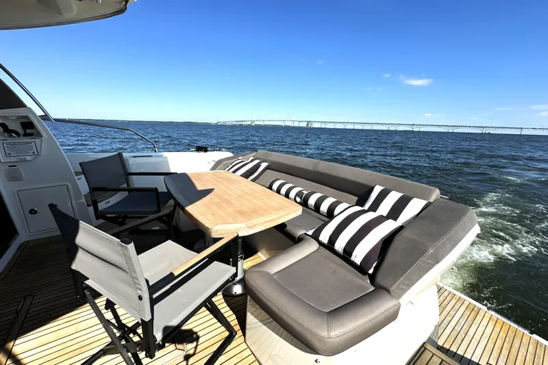 Eribella Yacht Photos Pics Luxury seating area on 2016 Prestige 500 S yacht with ocean view and striped cushions.