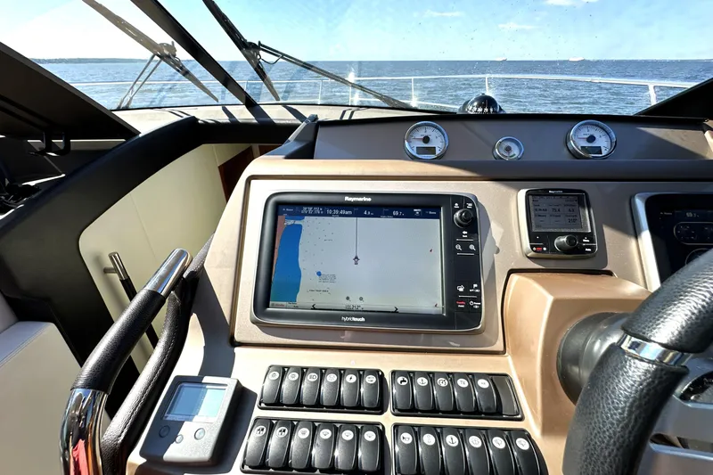 Eribella Yacht Photos Pics Cockpit view of 2016 Prestige 500 S yacht with navigation system and ocean backdrop.
