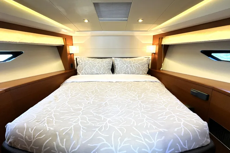 Eribella Yacht Photos Pics Luxurious bedroom interior of 2016 Prestige 500 S yacht with elegant bedding and ambient lighting.