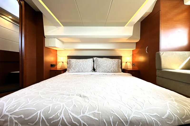 Eribella Yacht Photos Pics Luxurious bedroom interior of 2016 Prestige 500 S yacht with elegant bedding and warm lighting.