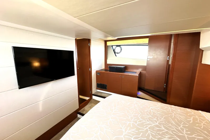 Eribella Yacht Photos Pics Luxurious interior of 2016 Prestige 500 S yacht with TV and elegant wood finish.