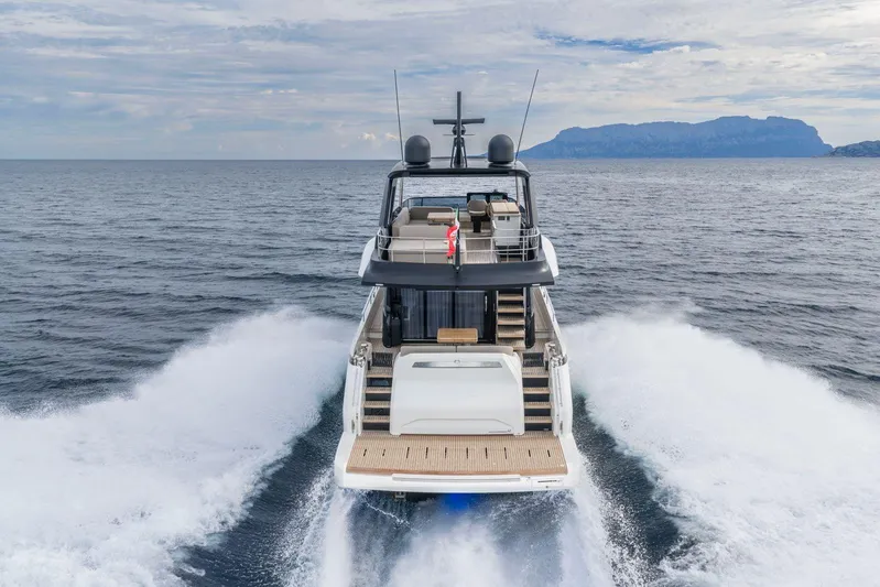  Yacht Photos Pics 2026 Cranchi 62 yacht cruising on open sea with scenic mountain backdrop.