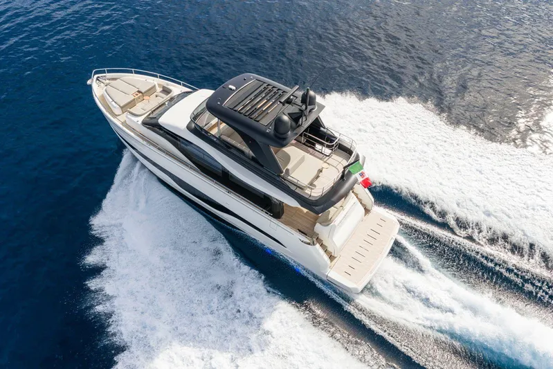  Yacht Photos Pics Luxurious 2026 Cranchi 62 yacht cruising on open blue sea.