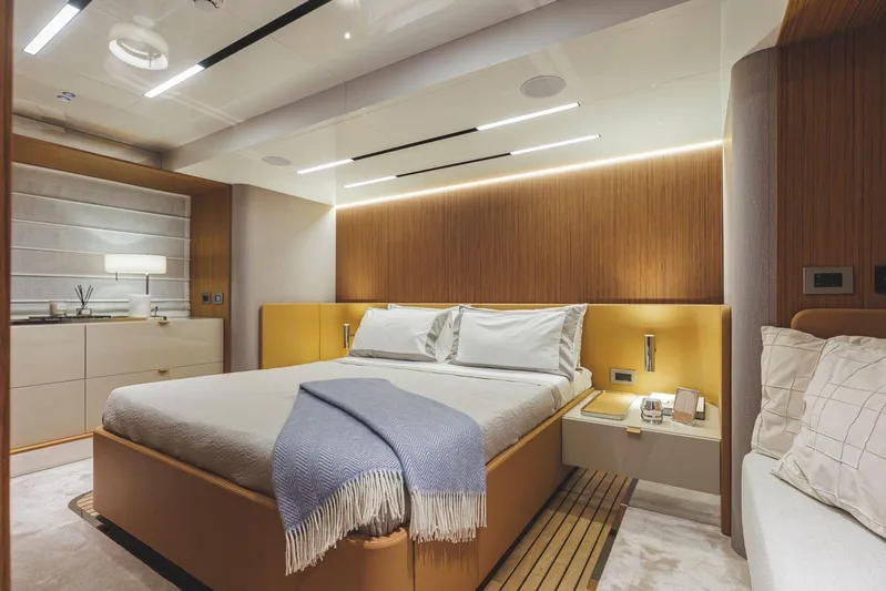  Yacht Photos Pics Luxurious bedroom interior of 2026 Cranchi 62 yacht with modern design and ambient lighting.