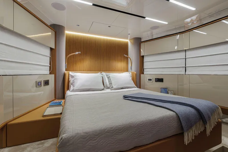  Yacht Photos Pics Luxurious bedroom interior of 2026 Cranchi 62 yacht with modern design and ambient lighting.