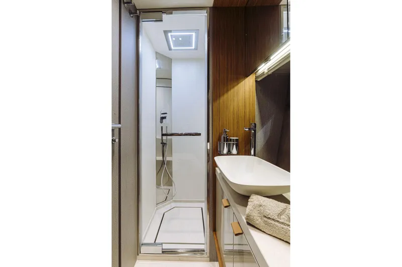  Yacht Photos Pics Luxurious bathroom interior of 2026 Cranchi 62 yacht with modern shower and sink.