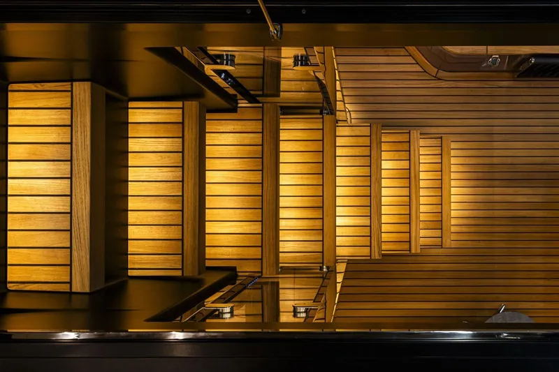  Yacht Photos Pics Luxurious wooden staircase on 2026 Cranchi 62 yacht, featuring elegant lighting and sleek design.