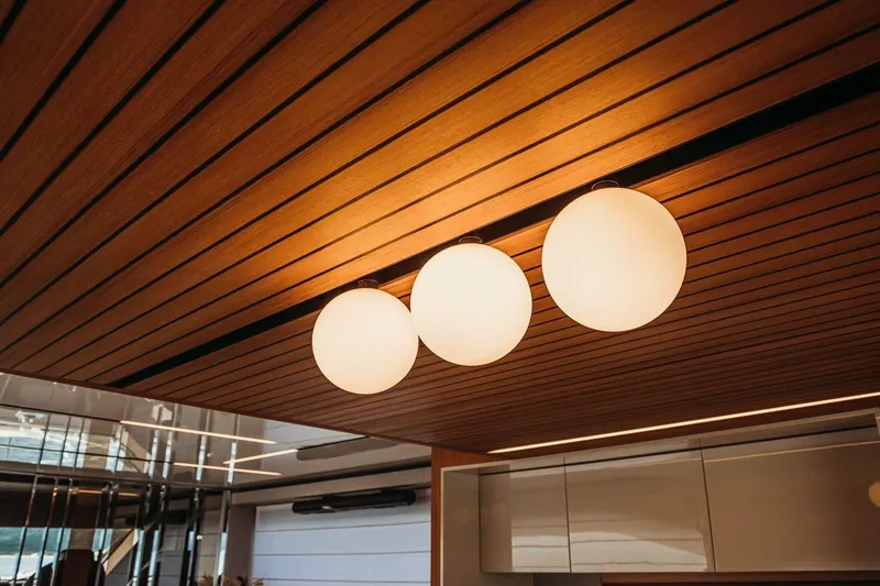  Yacht Photos Pics Modern interior lighting on Cranchi 62 yacht, 2026 model, with wooden ceiling design.