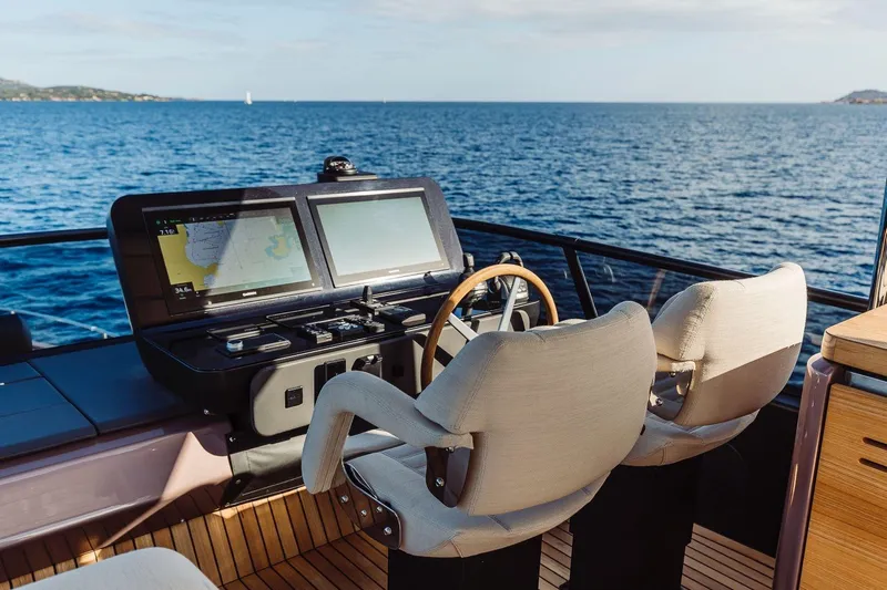  Yacht Photos Pics Luxury helm of 2026 Cranchi 62 yacht with dual navigation screens, ocean view.