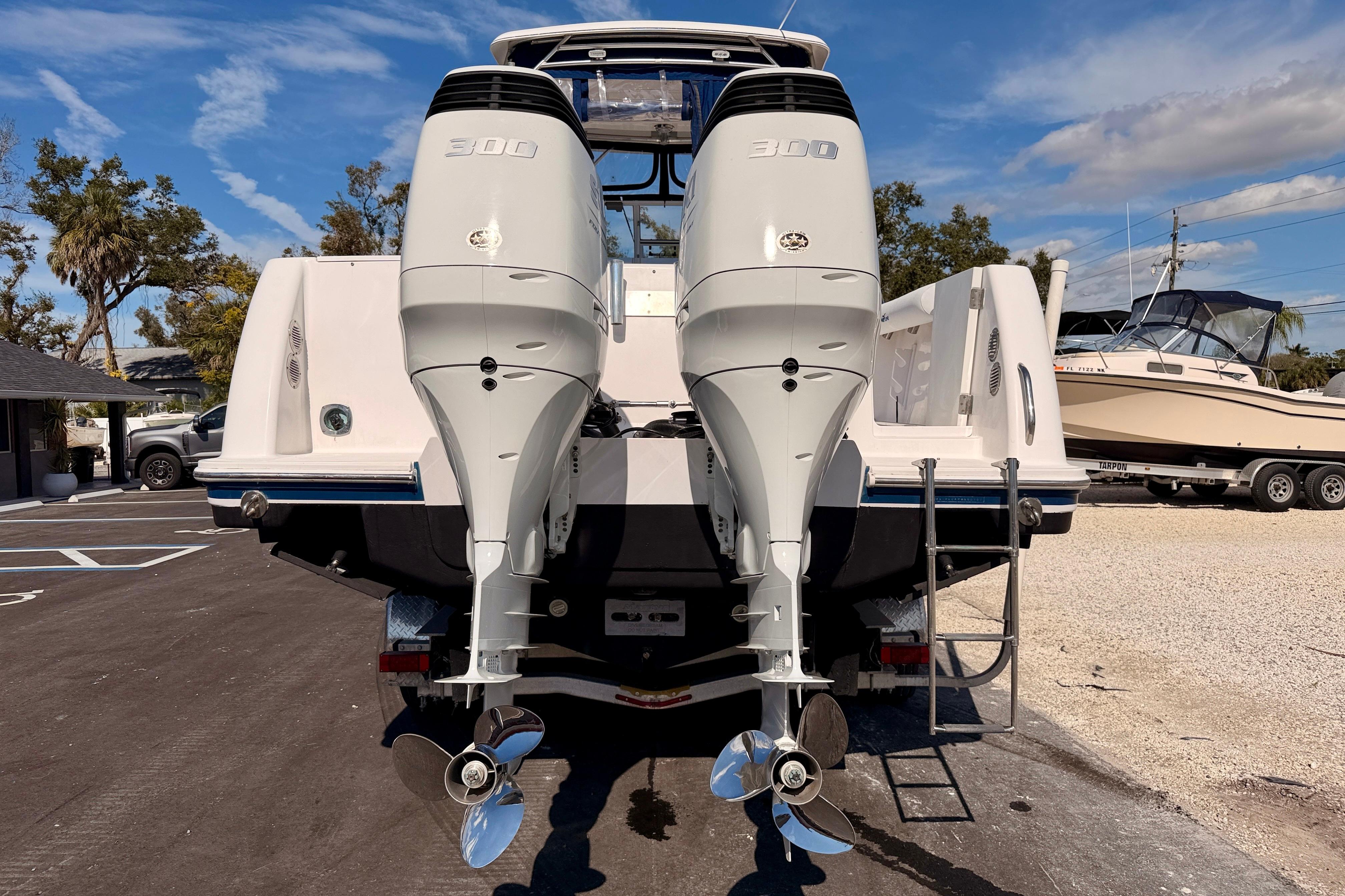 2007 Pro-Line 32 Express boat with dual 300 horsepower engines, parked outdoors.