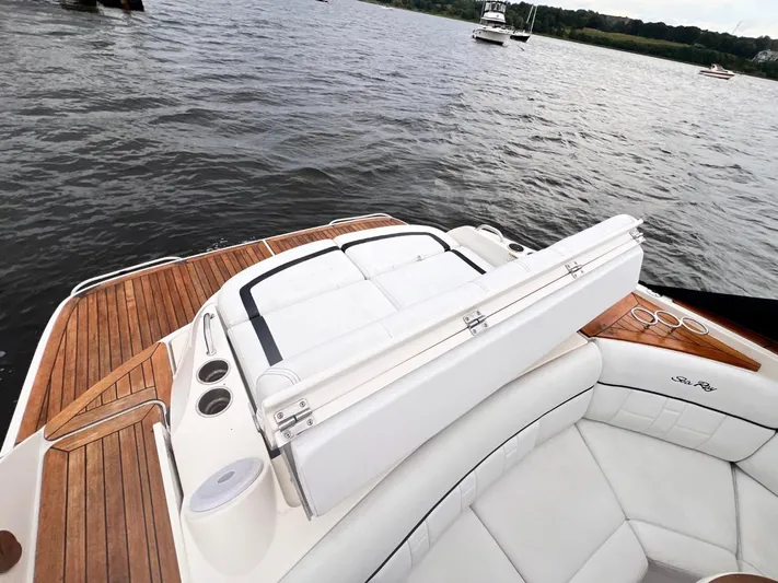  Yacht Photos Pics 2014 Sea Ray 350 SLX boat with white seating and wooden deck on a calm lake.