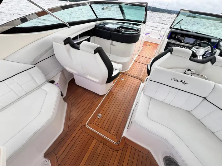  Yacht Photos Pics Interior of 2014 Sea Ray 350 SLX boat with white seating and wooden flooring.