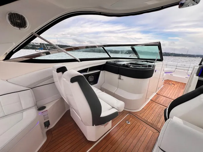  Yacht Photos Pics Luxurious interior of 2014 Sea Ray 350 SLX boat with sleek seating and wooden flooring.