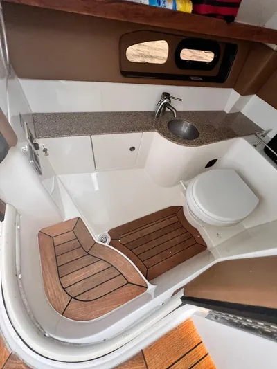  Yacht Photos Pics 2014 Sea Ray 350 SLX boat bathroom with sink, toilet, and wooden flooring.