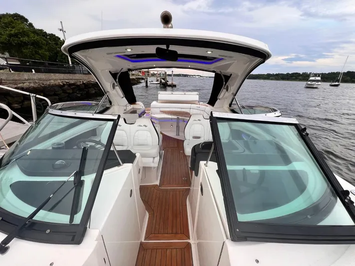  Yacht Photos Pics 2014 Sea Ray 350 SLX boat with open deck, docked by the water.