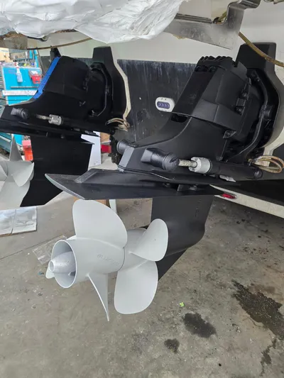  Yacht Photos Pics 2014 Sea Ray 350 SLX boat propellers and outdrives in a maintenance setting.