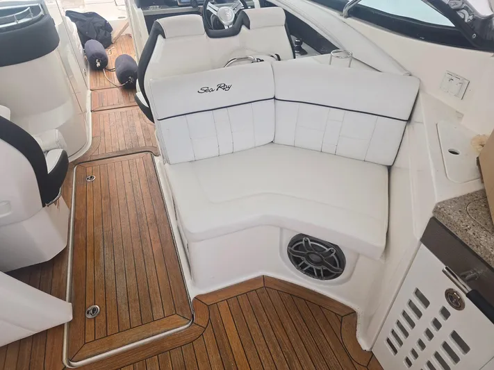  Yacht Photos Pics 2014 Sea Ray 350 SLX boat interior with white seating and wood flooring.