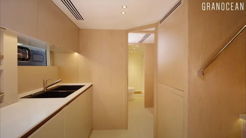  Yacht Photos Pics Modern kitchen interior of Granocean W-72 yacht, 2026 model, featuring sleek cabinetry and lighting.