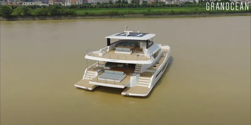  Yacht Photos Pics Luxury Granocean W-72 yacht cruising on a calm river, showcasing modern design and spacious decks.