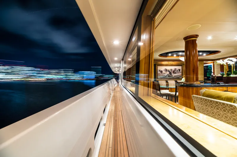 Serengeti Yacht Photos Pics Luxurious 2002 Westport Flybridge yacht at night, showcasing elegant interior and city lights.