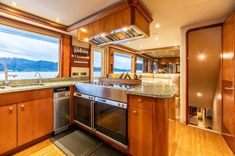 Serengeti Yacht Photos Pics Luxurious kitchen interior of a 2002 Westport Flybridge yacht with modern appliances and wood finishes.