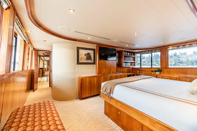 Serengeti Yacht Photos Pics Luxurious master bedroom on a 2002 Westport Flybridge yacht with wood paneling and large windows.