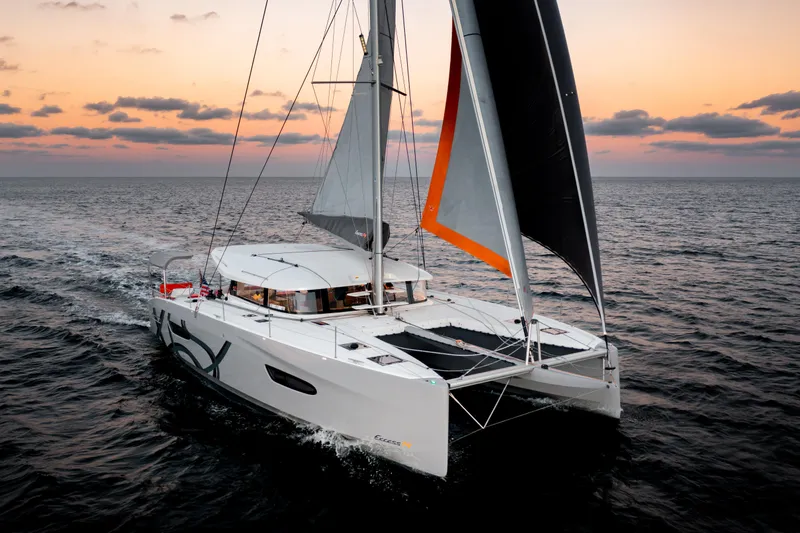  Yacht Photos Pics Sailing catamaran Excess 14, 2026 model, cruising at sunset on open sea.