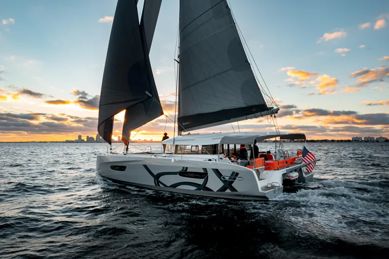  Yacht Photos Pics Sailing yacht Excess 14, 2026 model, cruising at sunset on open water.