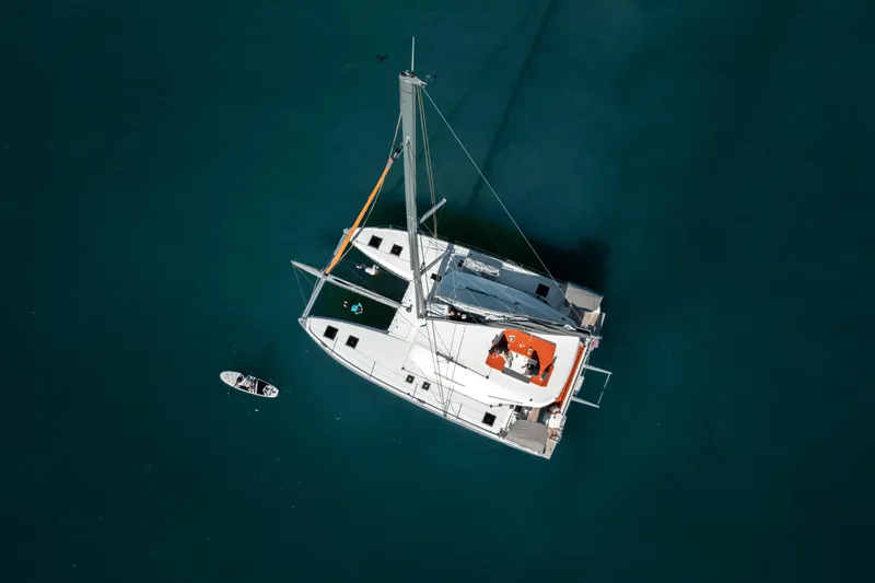  Yacht Photos Pics Aerial view of 2026 Excess 14 catamaran on calm blue water.