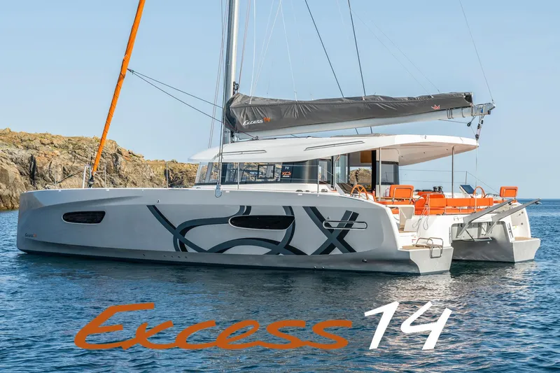  Yacht Photos Pics Excess 14 catamaran 2026 on calm water near rocky coast.