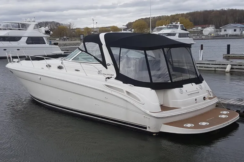  Yacht Photos Pics 2003 Sea Ray 380 Sundancer yacht docked in a marina, featuring a sleek design and black canopy.