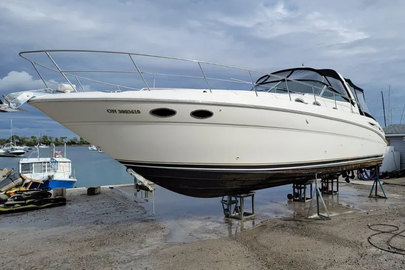  Yacht Photos Pics 2003 Sea Ray 380 Sundancer yacht on stands, dockside, under cloudy sky.