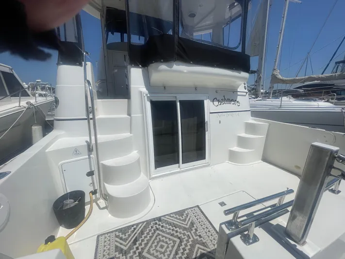  Yacht Photos Pics 2004 Carver 44 Cockpit Motor Yacht with stairs and sliding doors, docked at marina.