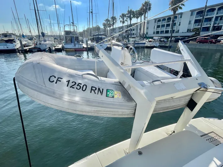  Yacht Photos Pics A 2004 Carver 44 Cockpit Motor Yacht with a small dinghy in a marina setting.