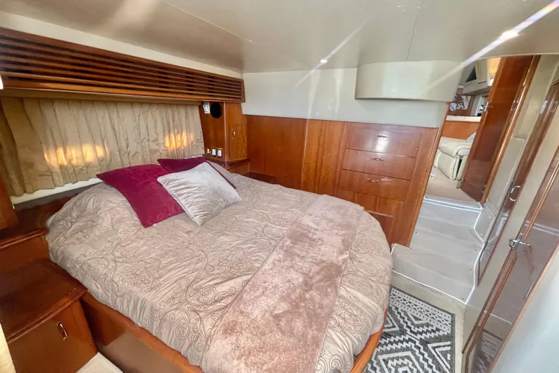  Yacht Photos Pics Luxurious bedroom interior of 2004 Carver 44 Cockpit Motor Yacht with elegant wood finish.