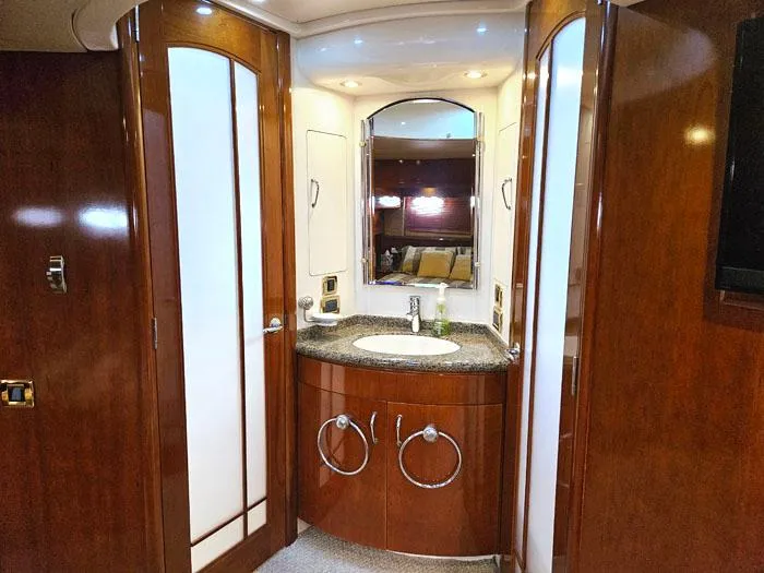  Yacht Photos Pics Luxurious bathroom in 2004 Carver 560 Voyager PH yacht with wood cabinetry and modern fixtures.