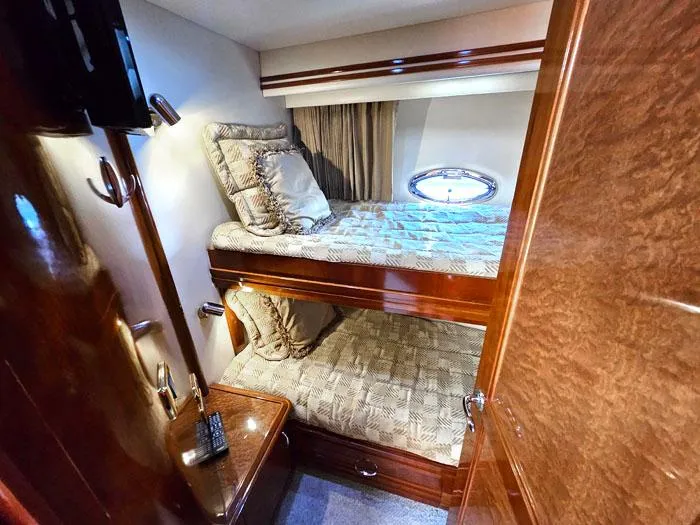  Yacht Photos Pics Luxurious cabin interior of 2004 Carver 560 Voyager PH with bunk beds and elegant wood finish.