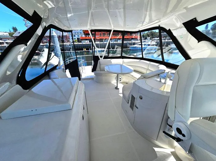  Yacht Photos Pics Luxurious interior of 2004 Carver 560 Voyager PH yacht with panoramic windows and seating.