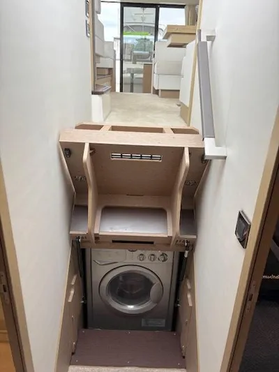 Yore Amuche Yacht Photos Pics Compact laundry area in a 2019 Prestige 520S yacht, featuring a built-in washing machine.