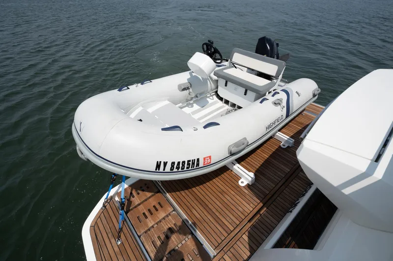 Yore Amuche Yacht Photos Pics Inflatable boat on Prestige 520S yacht, 2019 model, docked on wooden platform.